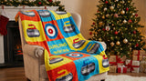 Colorful 'Curling Rocks' blanket draped over a chair in a festive living room with a Christmas tree and presents.